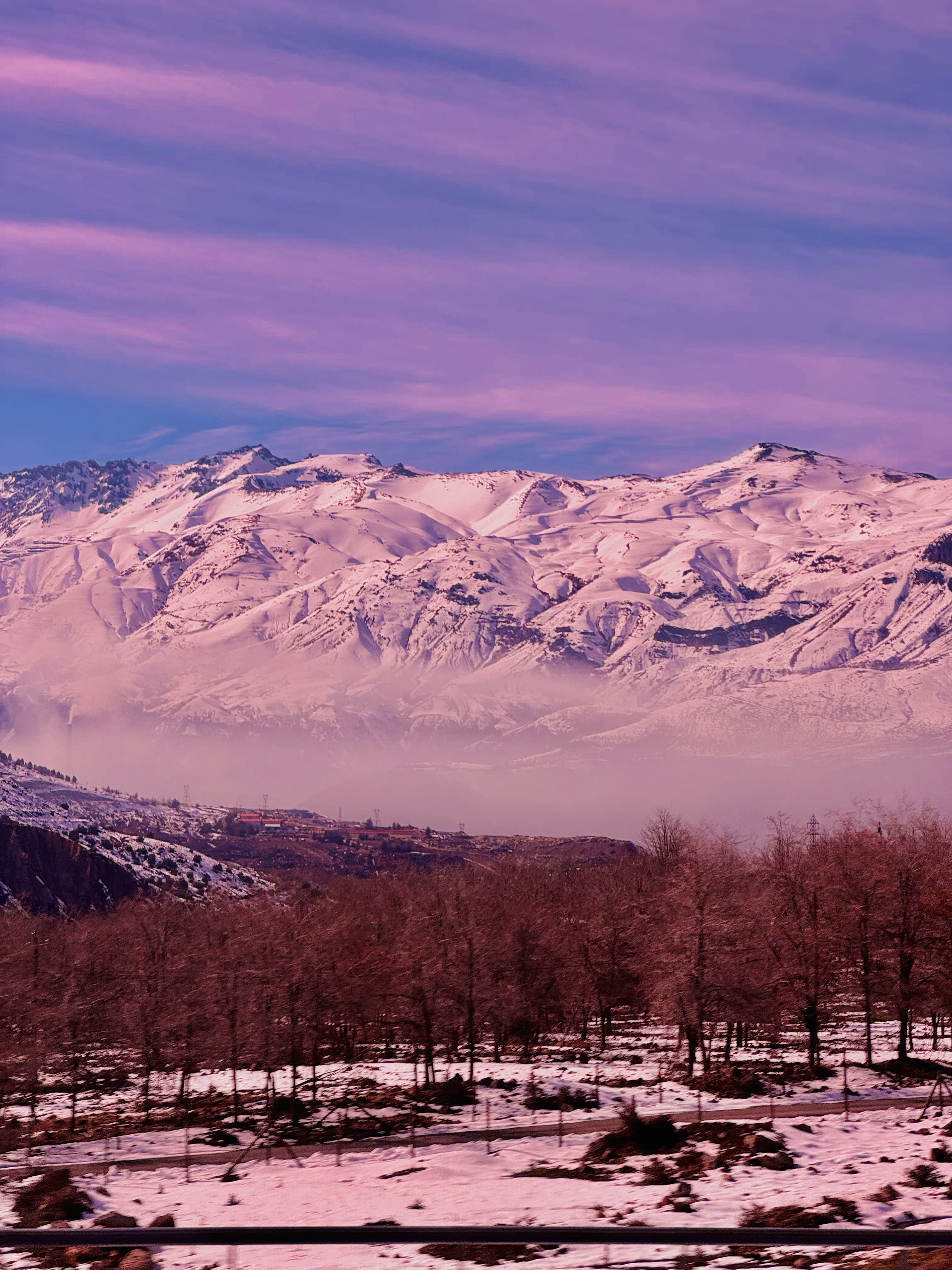 Pink-toned, dreamy-looking picture of the Andes mountains in Chile.